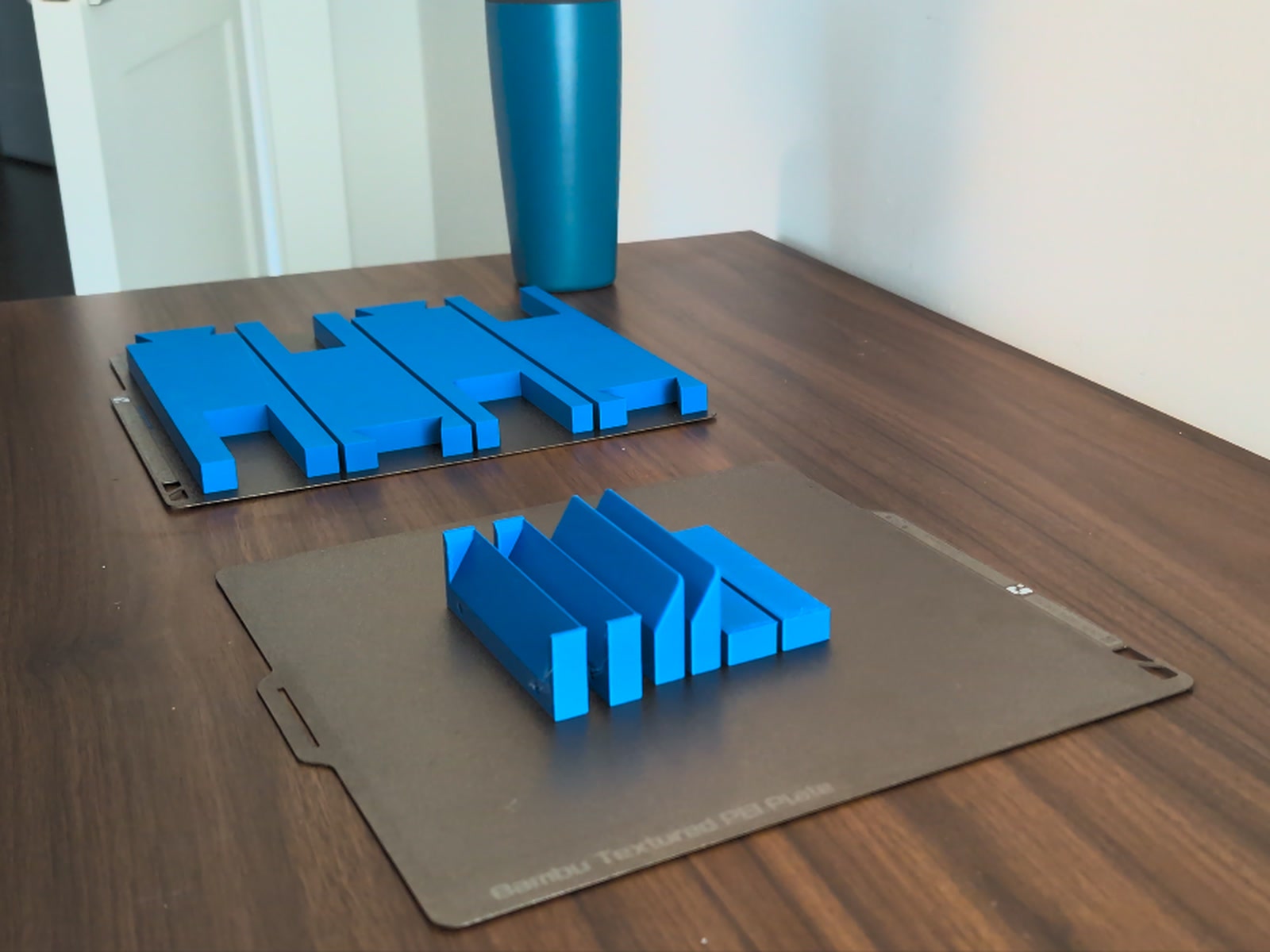 Blue printed French cleats and alignment guides on build plates