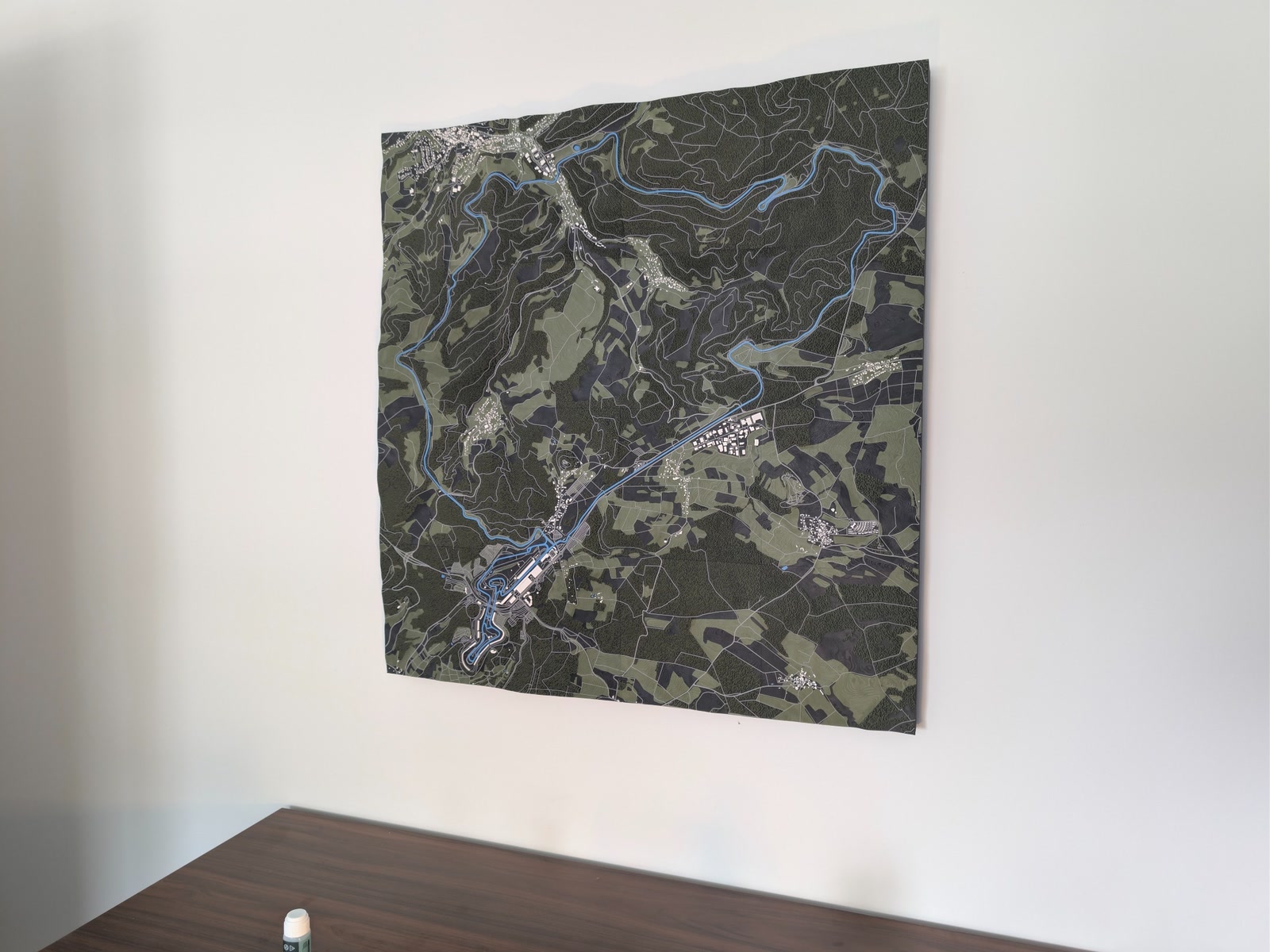 The unframed Nürburgring model mounted on a wall